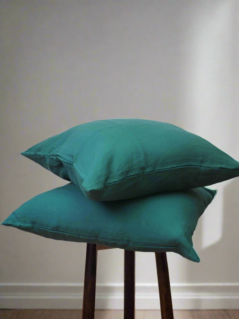 Linen Cushion Cover in Forest - TSL| two dark green cushions placed on a stool 