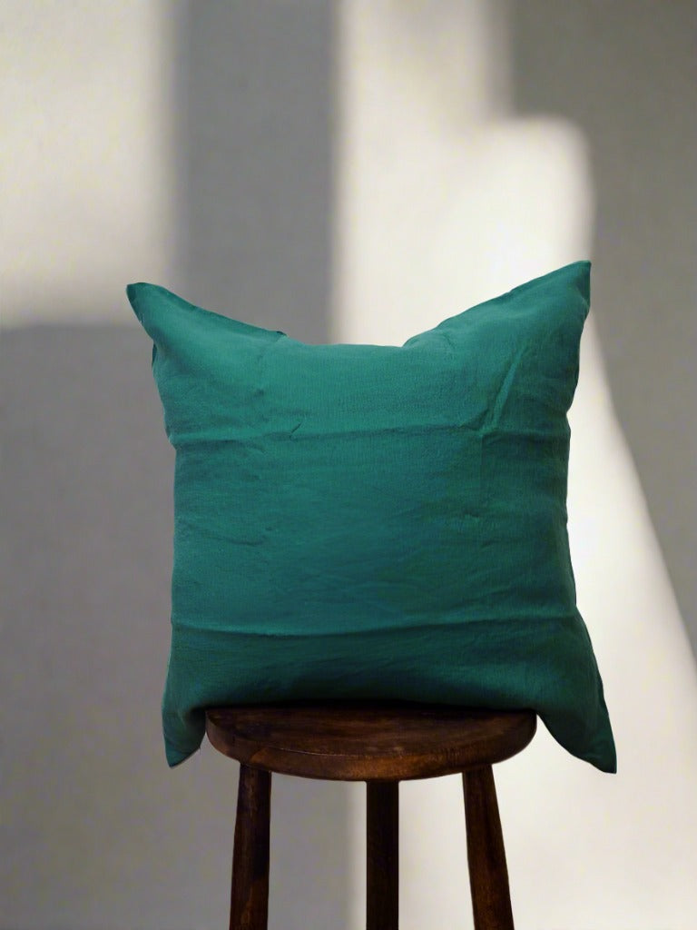 Linen Cushion Cover in Forest - a dark green cushion placed on a stool | TSL