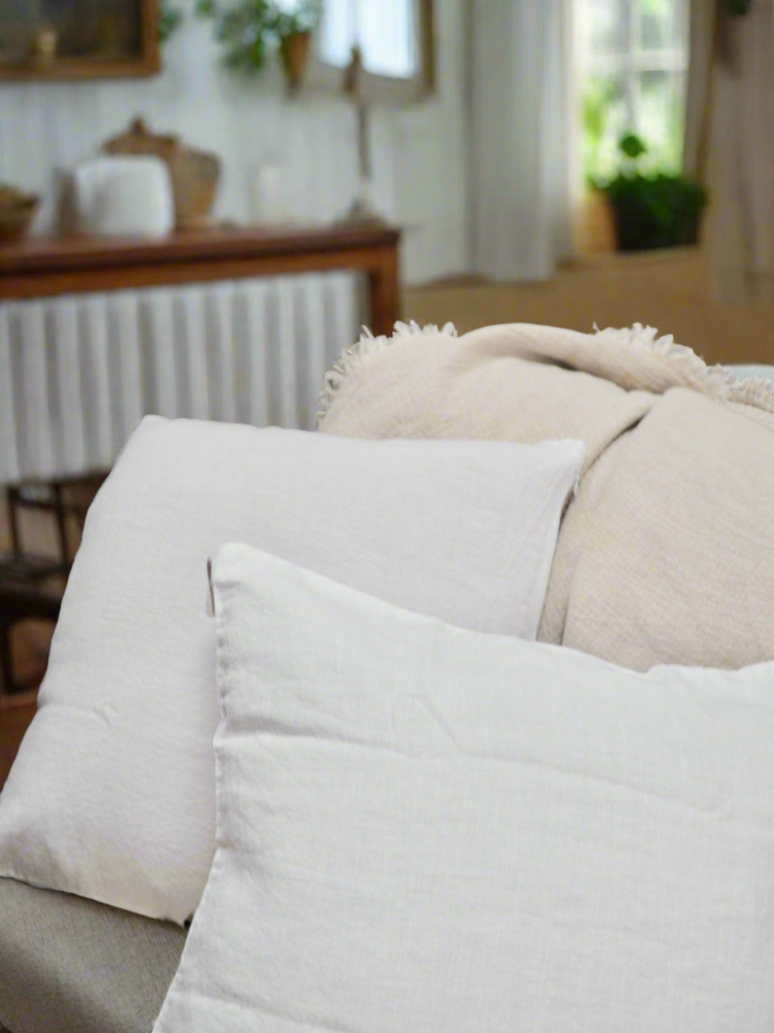 Linen Cushion Cover in White - TSL, two linen cushions placed on a couch in a living room 